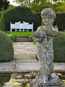 Cherub statue with white garden