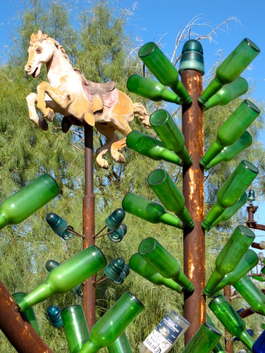 Bottle tree capped with a rocking horse