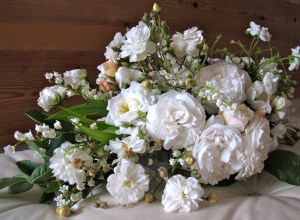 A bouquet of white garden roses with lily of the valley