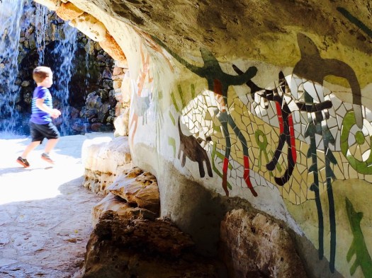 Child Running Through A Grotto
