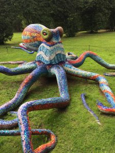 Mosaic octopus sculpture outdoors on the grass
