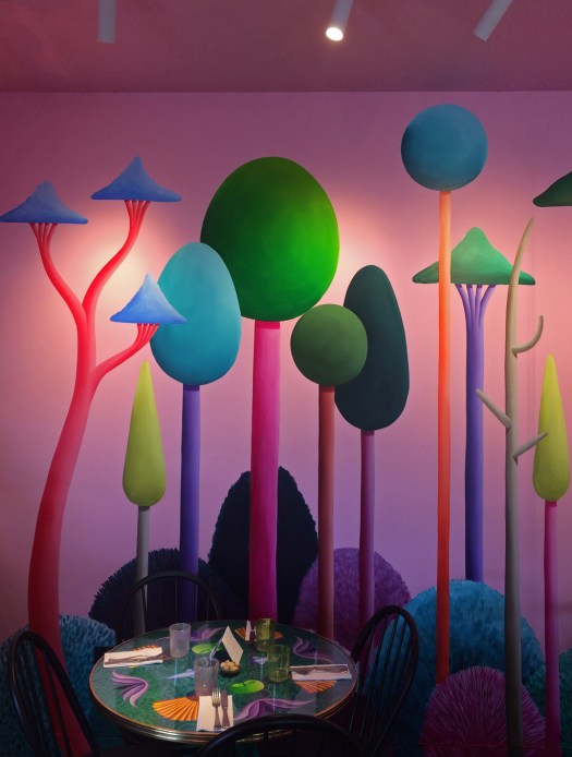 Nicola's Party's naive woodland mural is a colourful backdrop for cafe table