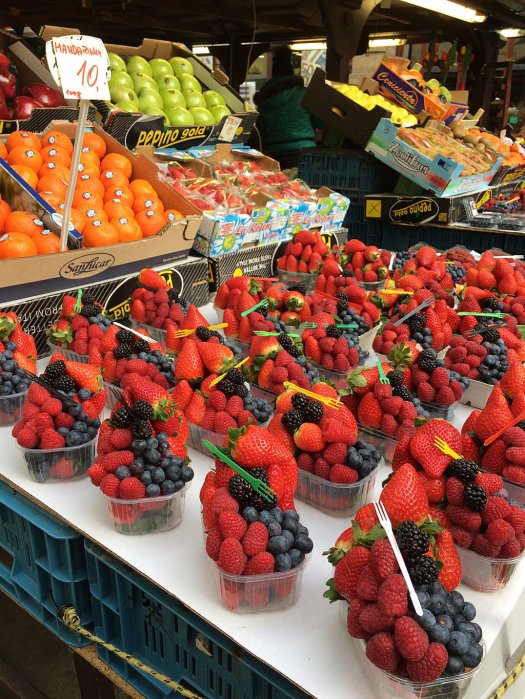 Heaped packs of berries with forks