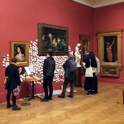 People looking at a Pre-Raphaelite painting with post-it messages