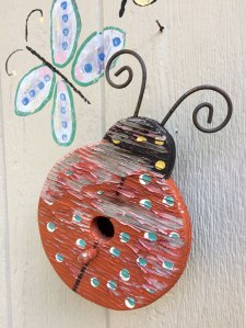 A small birdhouse shaped like a ladybird
