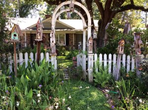 An arched garden entrance in a picket fence