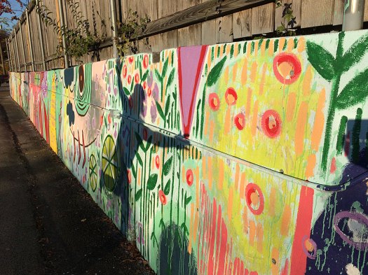 Shadow of a man against a colourful mural