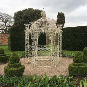 White gazebo with decorative wirework