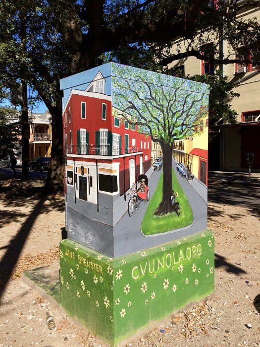 Utility box with painting of tree and street scene