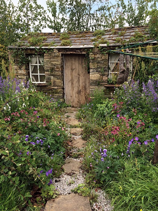 Stone and gravel path through a cottage garden