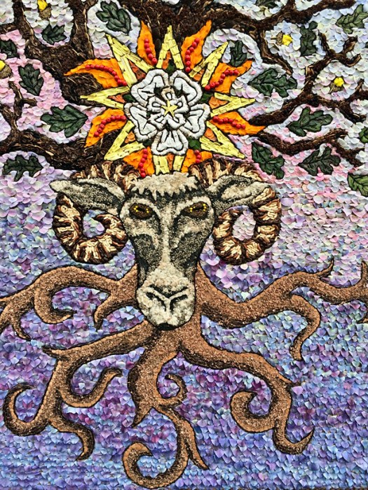 Tree roots and leaves with a ram's face