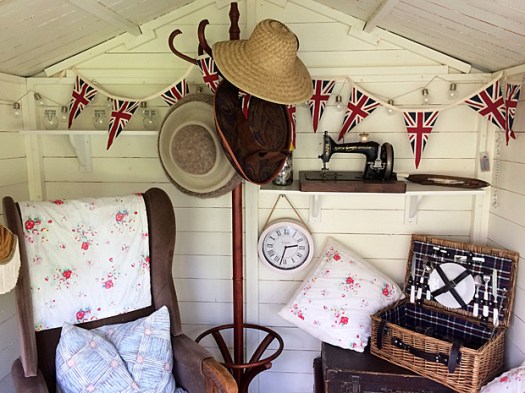 Summer house with chair, picnic hamper and bunting