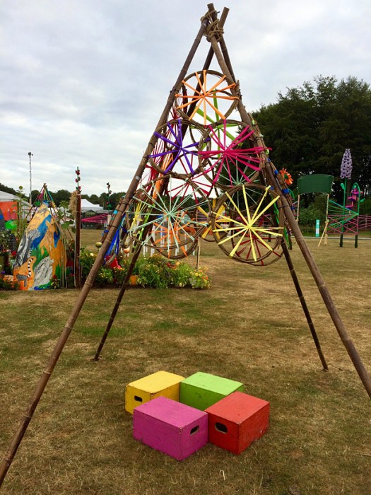 Cane teepee with colourful raffia circles and seating