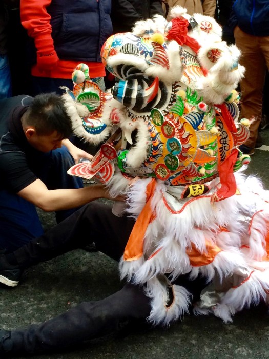 Lion dancer during a pause in the dancing