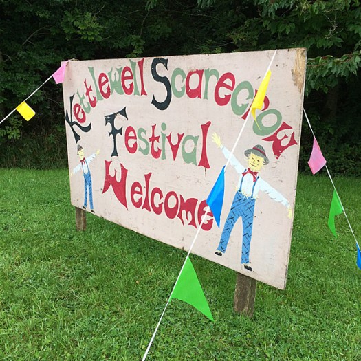 Welcome sign with scarecrows and bunting