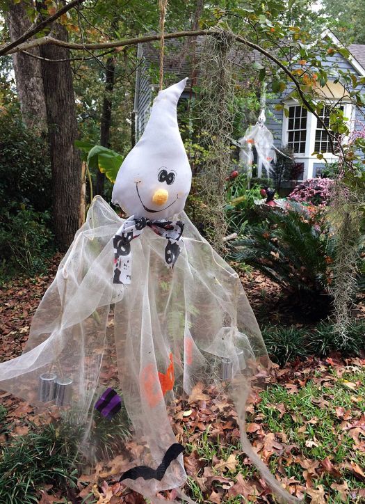Smiling ghost figure in a garden