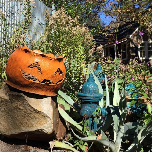 Halloween tyre planter with a face cut into it