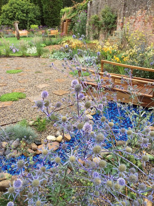 Prickly flowers over a river of bold blue broken glass