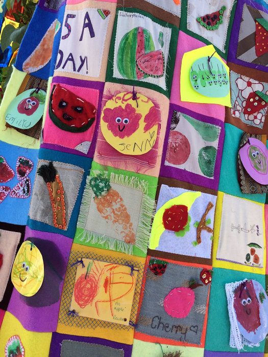 Fruit artwork squares, some with smiles drawn on them