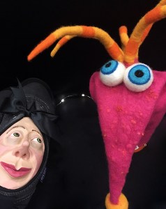 A shoe with a human face and a big-eyed glove puppet