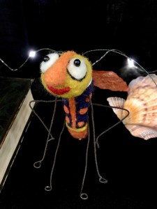 Bug with metal legs and a colourful body