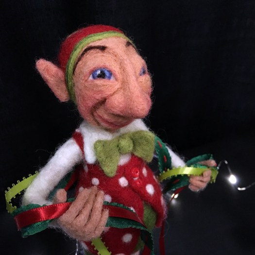 Elf in Christmas costume with bow tie and ribbons