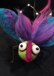 Butterfly with pink nose, green face and purple wings