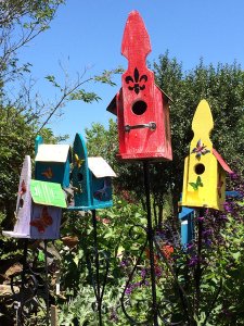 Red, yellow, blue and purple bird houses