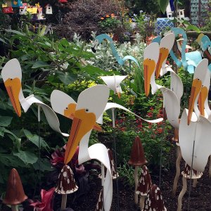 White metal pelicans and blue flamingos