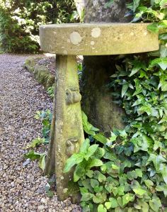 Semicircular stone seat in the Arts and Crafts style
