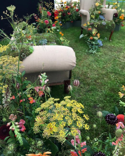 Sneak peek of a floral display with armchairs