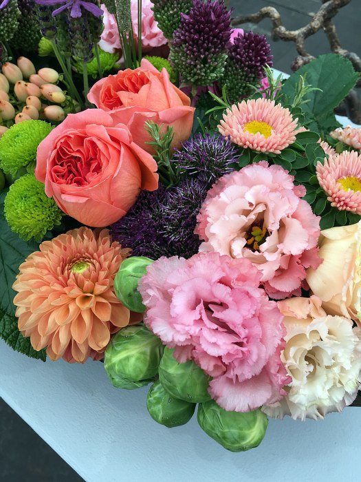Orange roses, dahlias, lisianthus and brussels sprouts