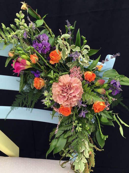 Chair back decorated with rose buds, foliage and flowers