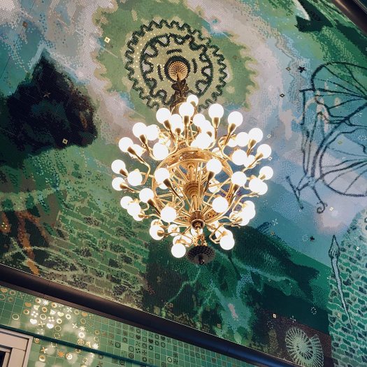 Gilded metal chandelier made with recycled bicycle parts