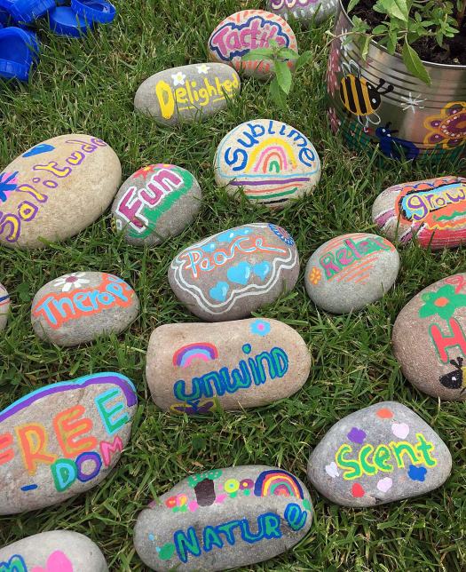 Words on pebbles: unwind, scent, nature, solitude, sublime etc