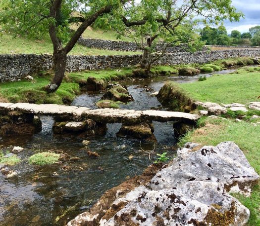 Bridge over a river in a landscape with dry stone walls