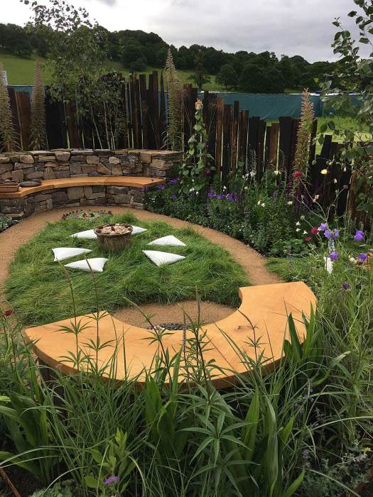 Oval path with a bench at each end and a mandala making area in the middle