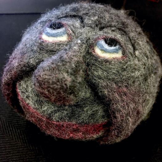 Felt stone with face - member of a rock group