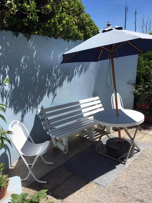 Outdoor furniture and parasol in the Barbara Hepworth garden