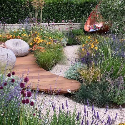 Garden with decking, winding path, and copper swing seat