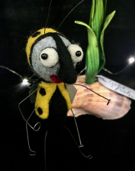 Felt bug with cute expression and polka dot body