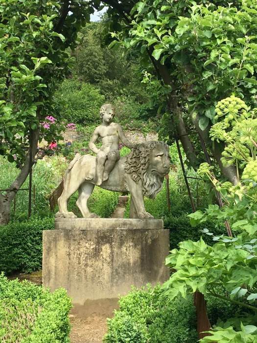 Statue of a child riding a lion in Chatsworth Kitchen garden