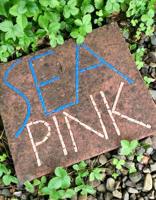 Sea Pink written in colour on a square stone