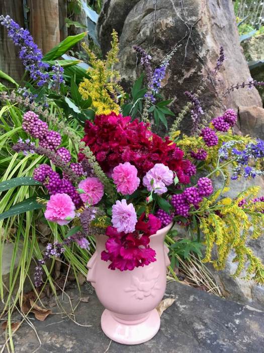 Flower arrangement with beautyberry, goldenrod, roses