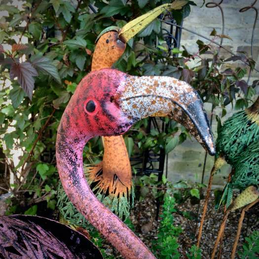 Metal birds, one with a hooked nose