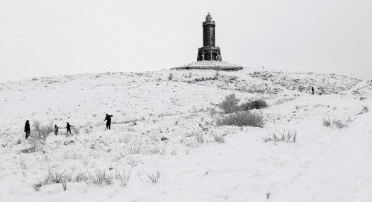 Walkers near Darwen Tower in the snow