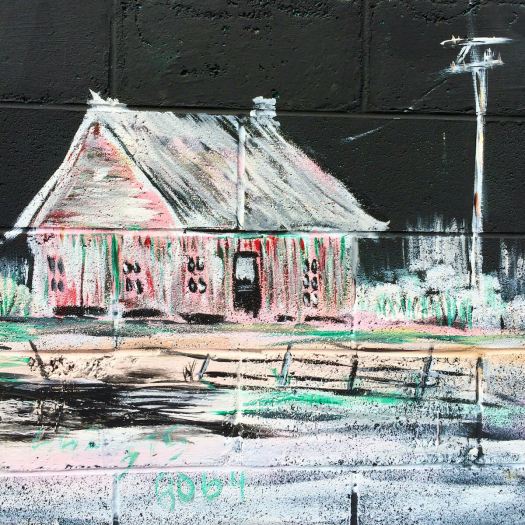 Drawing of pink shack on a black wall in Clarksdale