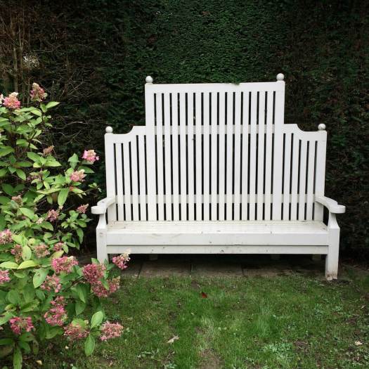 High-backed wooden garden bench, painted white