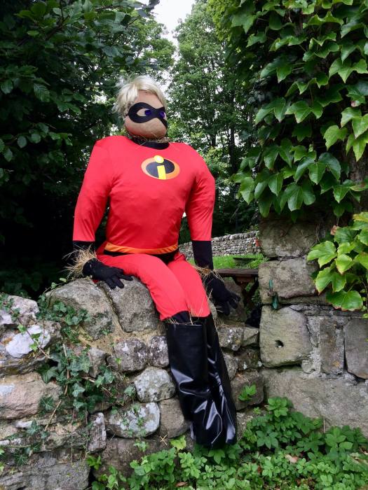 Mr Incredible scarecrow on a stone wall