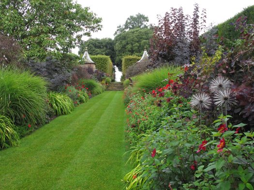 View down the double red borders at Hidcote